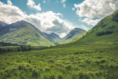 grass field below mountain