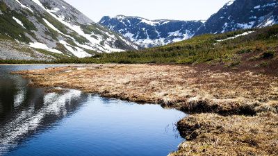 snowy mountains behind a lake