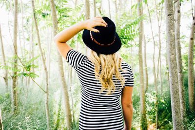 girl standing in forest