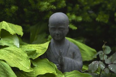 statue of a little boy in garden