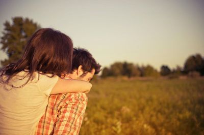 man and girl are hugging