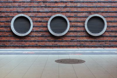 round vents on a brick wall