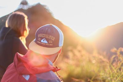 man and woman watching sunset