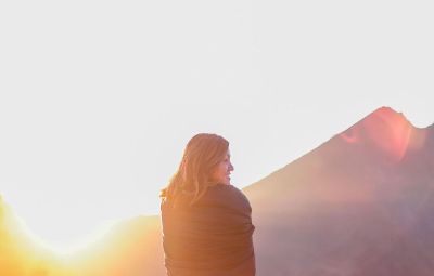 girl watching sunset in mountains