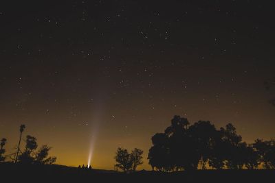 light goes up into the night sky at country
