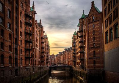 tall buildings separated by canal