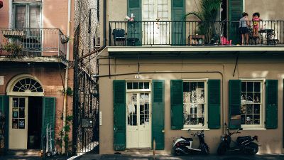 apartments with people sitting on balcony