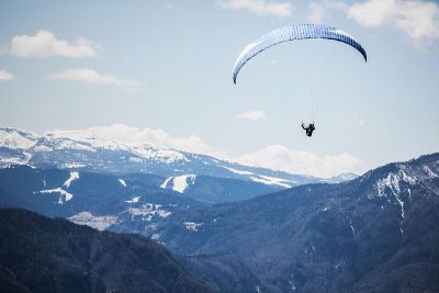 parachute hang glider over mountains
