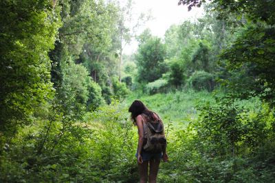 woman walking through forest