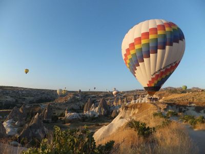 hot air balloons over rough terrain