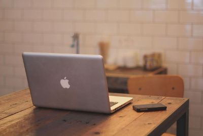 macbook and smartphone on wooden table