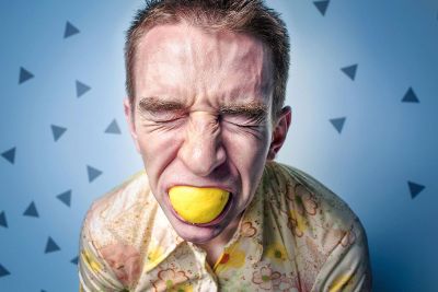 man eating lemon