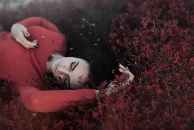 woman sleeping in bushes