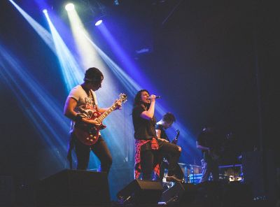 singer and guitarists on stage