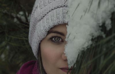 woman peeking out behind limb