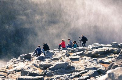 people sitting on a cliff