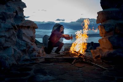 man starting a campfire