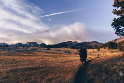 man hiking in desert field