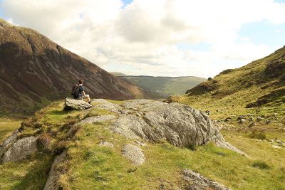 boy sitting on a mountain top