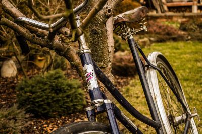 old bicycle leaning against stree