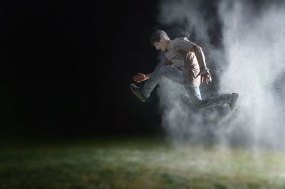 boy jumping in dusty air