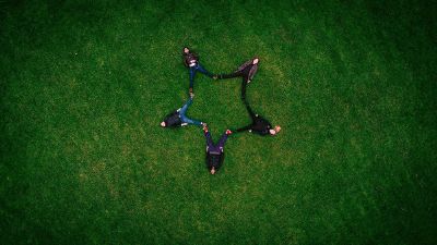 people laying in grass