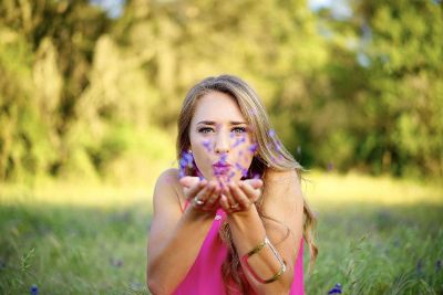 woman blowing petals