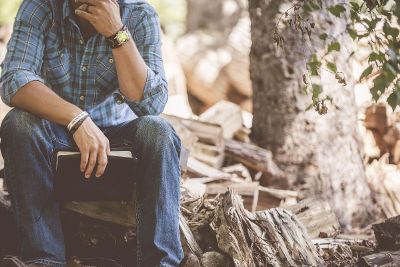 man sitting on the wood