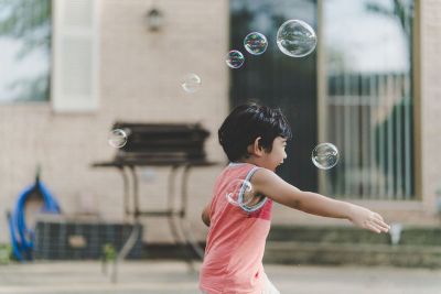 child playind with bubbles