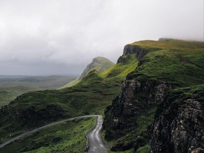 lonely road near green hills