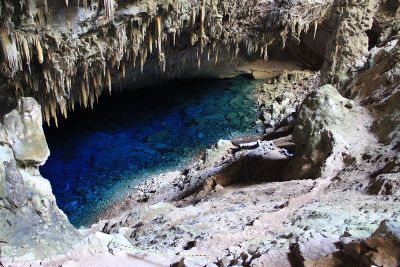 blue cave pool overhung with stalagtites