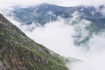 mountains rising above clouds