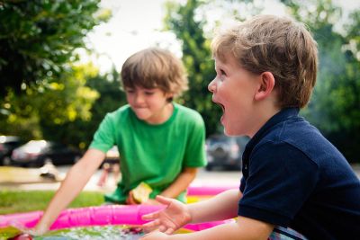 boys playing in a kiddie pool