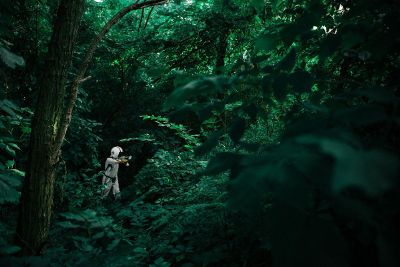 man playing paintball in a forest