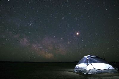 tent under vast night sky