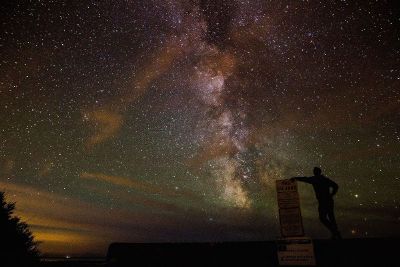 man looking up at starry sky