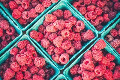 red raspberries in a green carton