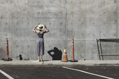 woman adjusting hat