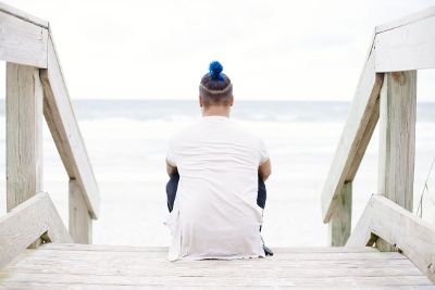 human meditating by water