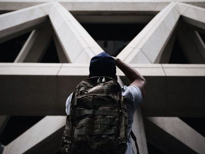 person looking up at building