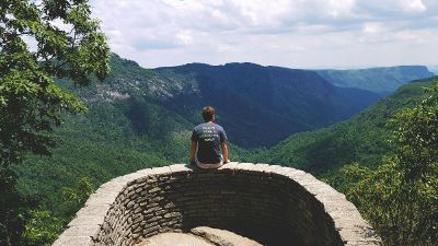 young man sitting on wall