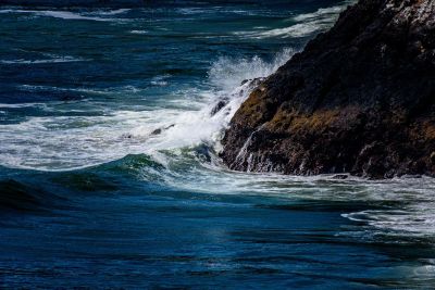 ocean waves beating against a cliff