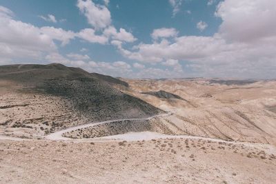 desert with winding road under blue sky