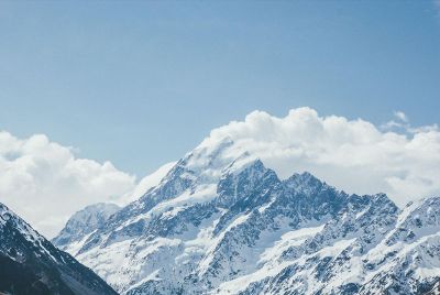 clouds over a snowy mountain