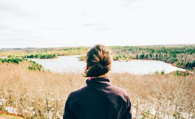 person looking out at lake