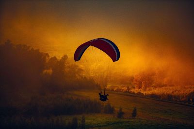 man flying with parachute