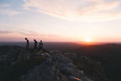 three men on a cliff