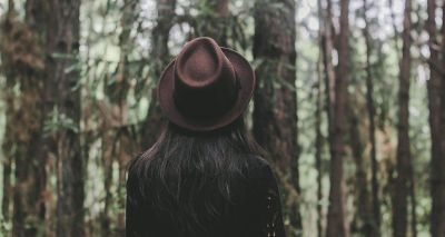 female looking into the woods