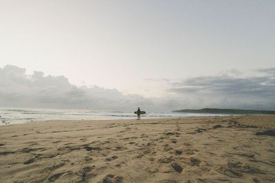 lone surfer on beach