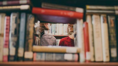 people behind bookshelf